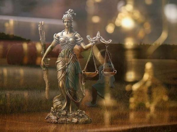 Boginja pravičnosti in pravni akti v ozadju