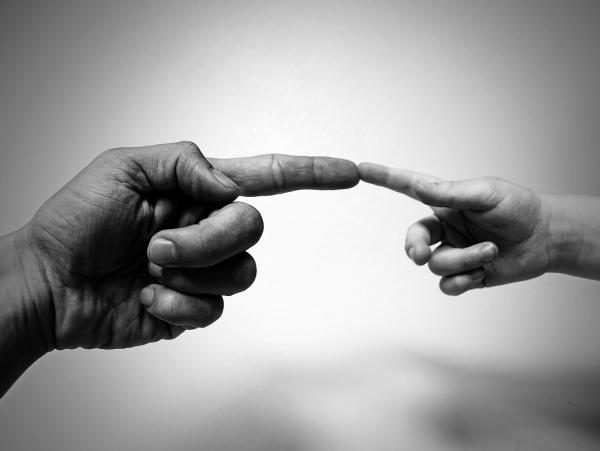 Child and adult fingers touching