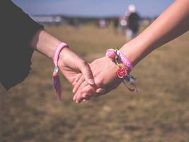 Two women holding hands