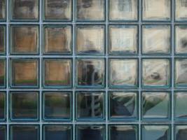 A bulletproof window representing a hospital in a prison